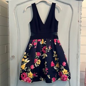 A semiformal dress with pockets! It has a solid top with floral design skirt